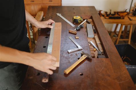 Man working with wood and ruler in carpentry studio · Free Stock Photo