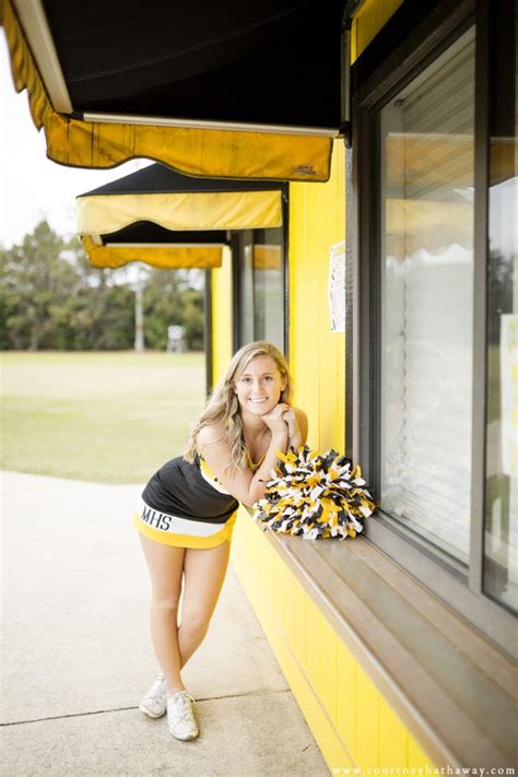 A Woman Leaning On The Side Of A Yellow Building Holding Onto A