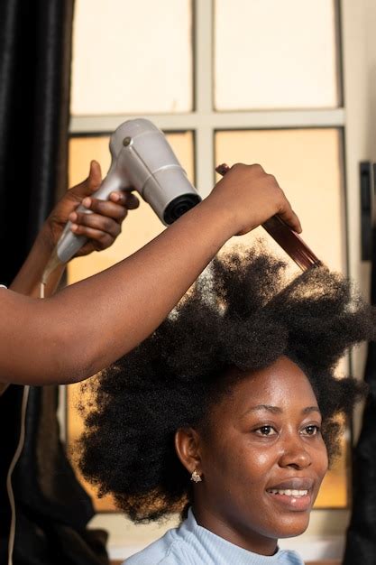 Free Photo Stylist Woman Taking Care Of Her Client Afro Hair