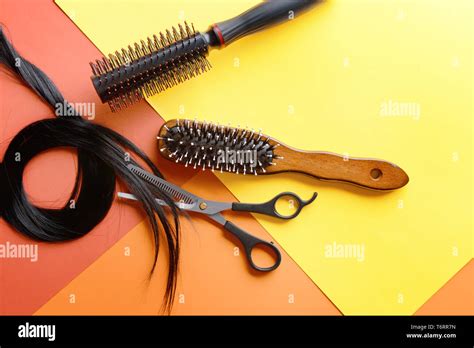 Flat Lay Composition With Hairdressers Tools And Strand Of Black Hair