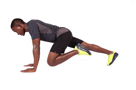 Sporty African Man Doing Mountain Climbers Ab Exercise