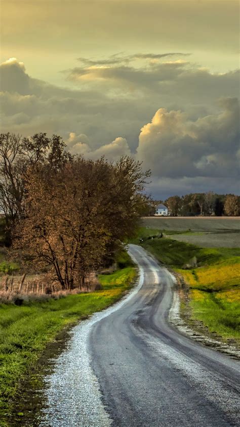 Road Between Grass Field And Fence Under Cloudy Sky 4k Hd Nature