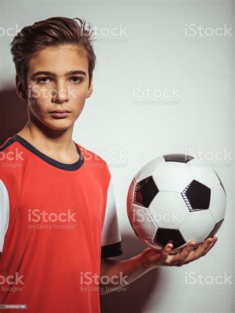 Photo Of Teen Boy In Sportswear Holding Soccer Ball Stock Photo