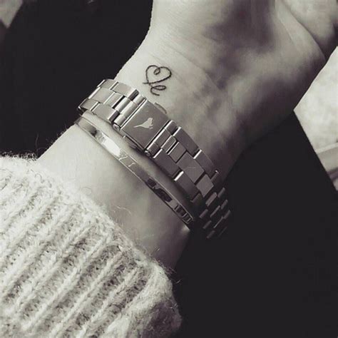 Small tattoos that mean a lot. Wrist tattoo saying "le", and drawing a heart as the ...