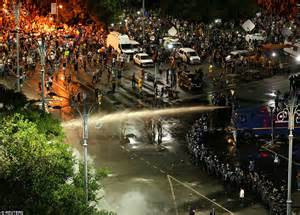 Riot Police Use Water Cannons And Tear Gas As Thousands Of Expat