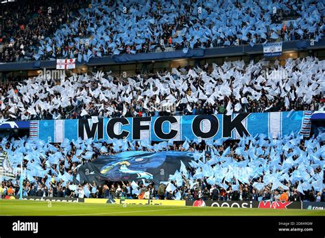 Manchester City Fans Wave Flags Ahead Of Kick Off Near A Banner That