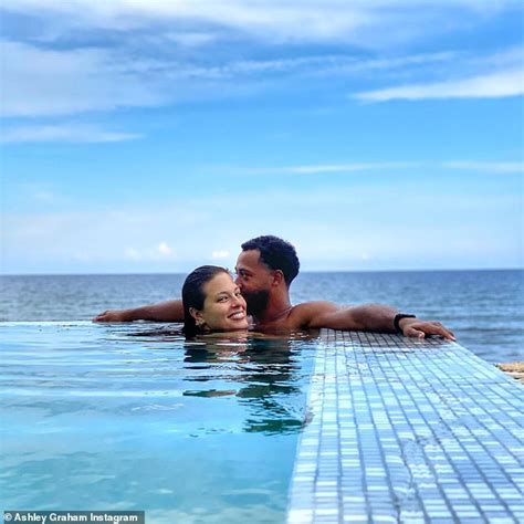 ashley graham packs on the pda in the pool with husband justin ervin during luxurious summer