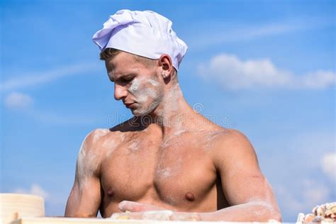 Man With Muscular Torso Works As Chef Cook Baker At Working Surface Covered With Flour Bakery