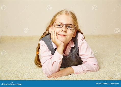 Portrait Of A Schoolgirl With Glasses Child At Home Stock Photo