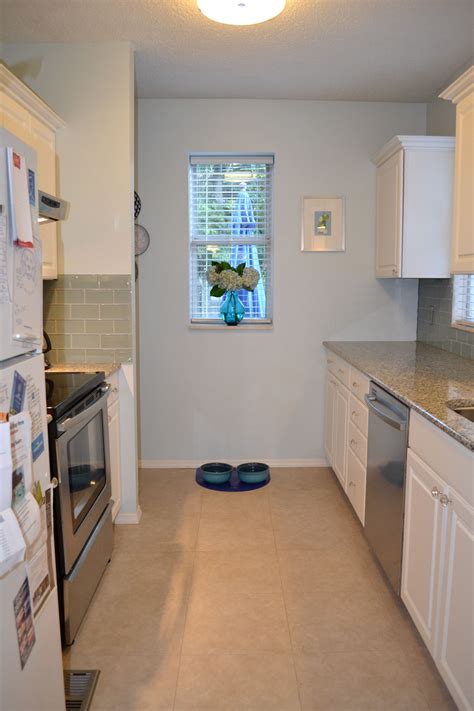Porcelain patterned wall & floor tile features timeless beauty design. White kitchen with light blue backsplash and azul platino ...