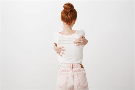 Free Photo Rear View Of Redhead Girl Hugging Herself