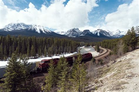 Freight Train Moving Along The Bow River In The Canadian Rockies In