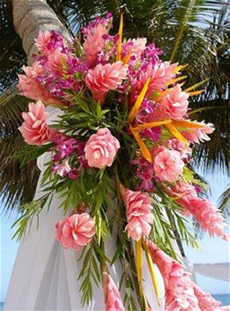 For a pop of color, the bridesmaids carried laura's favorite flower, pink gerbera daisies, paired with orange roses to tie in laura's bouquet. Beach Themed Wedding Bouquets Slideshow