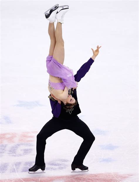 A Man And Woman Are Performing On The Ice