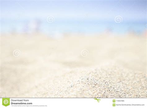 Blurred Beach Background With White Sand Blue Sea And Sky On Horizon