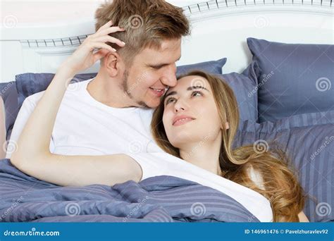 Beautiful Awakened Loving Couple In Bed In The Morning Young Adult Heterosexual Couple Lying On
