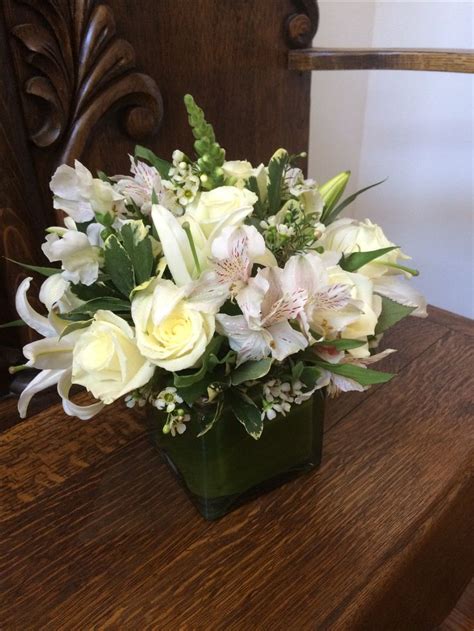 Video featuring products available on 1800flowers.com. White lilies and roses in cube with a Ti leaf wrap ...