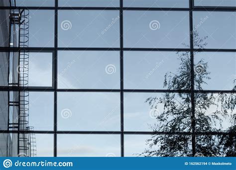 Glass Wall Of Business Center With Sky Reflection Modern Building With