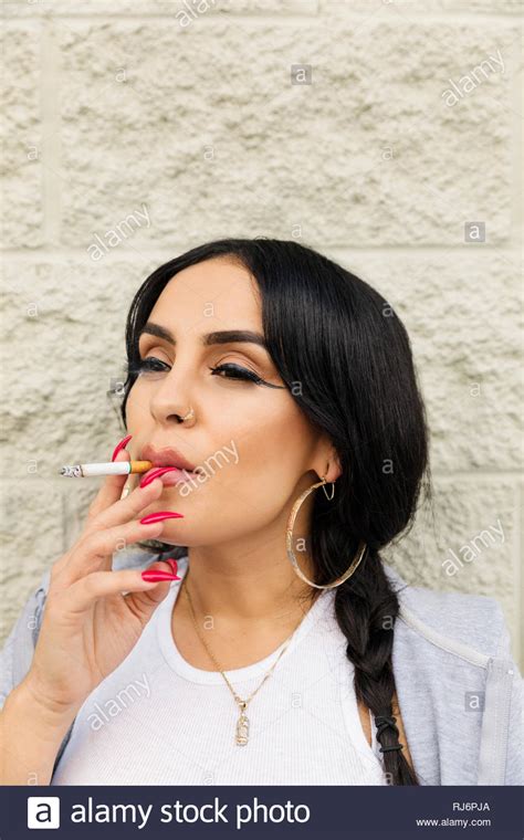 Latinx Young Woman Smoking Cigarette Stock Photo Alamy