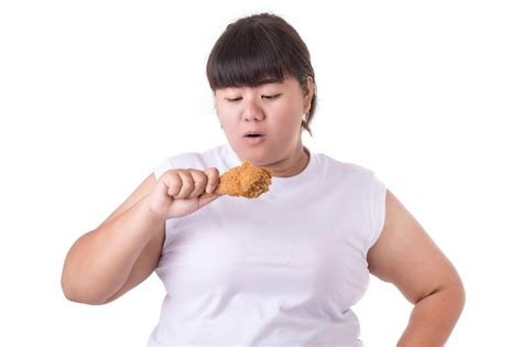 Premium Photo Fat Asian Woman Holding And Eating Fried Chicken