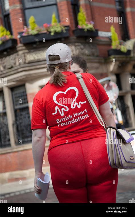 Rear View Of British Heart Foundation Charity Face To Face Female Fundraiser Charity Persuading