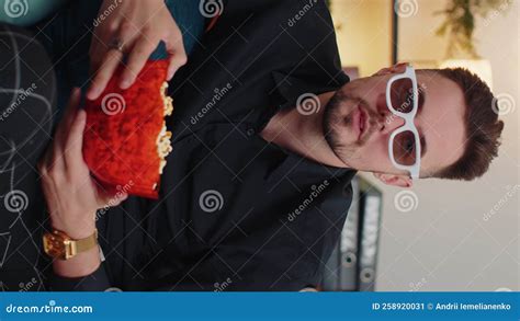 Guy Sitting On Couch Eating Popcorn And Watching Interesting Tv Serial