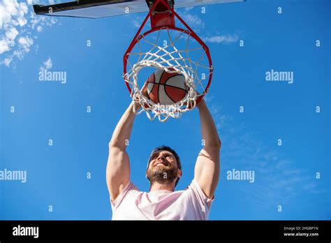 High View Of Basketball Player Throws The Ball Into The Hoop Outdoor