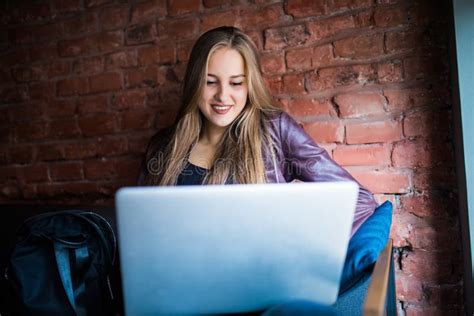 Beautiful Young Freelancer Woman Using Laptop Computer Sitting At Cafe