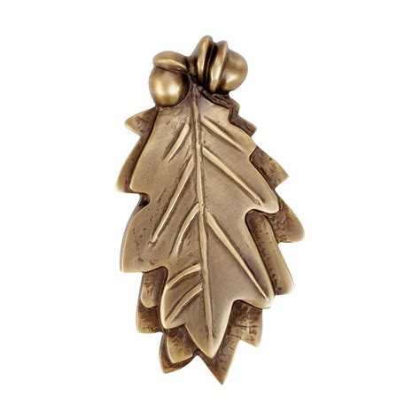 A door knocker has a part fixed to the door, and a part (usually metal) which is attached to the door by a hinge. Door Knocker Antique Brass Oak Leaf 6"H x 3"W