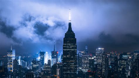 High Rising Buildings Of New York Under Cloudy Sky During Nighttime Hd