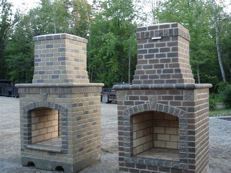 Two Brick Ovens Sitting Next To Each Other On Top Of Gravel Covered