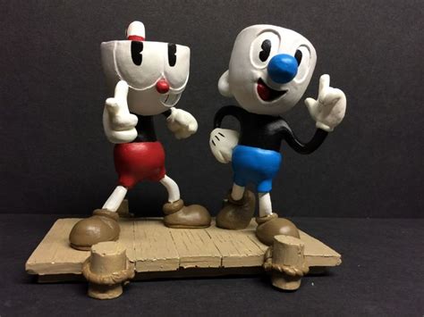 Two Figurines That Look Like Cartoon Characters