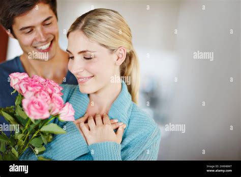 Give Her Roses Just Because Shot Of An Affectionate Young Man Giving His Beautiful Young Wife A