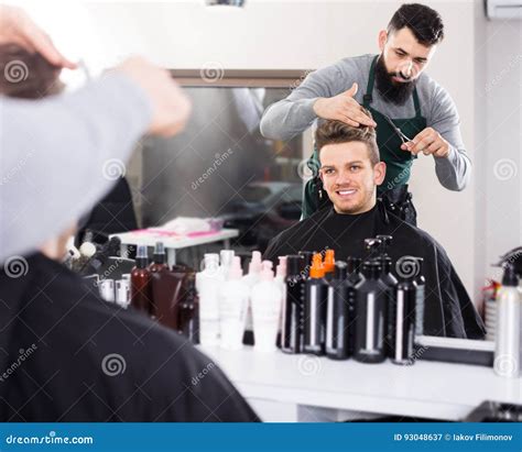 Guy Stylist Creating Haircut For Man Client At Hairdressing Salon Stock