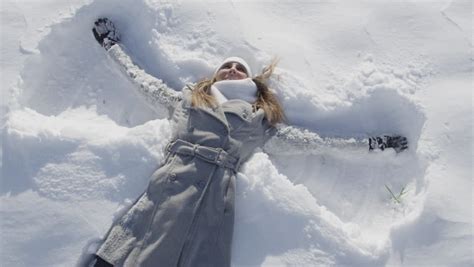 Slow Motion Close Up Cheerful Young Woman Making Snow Angels Stock