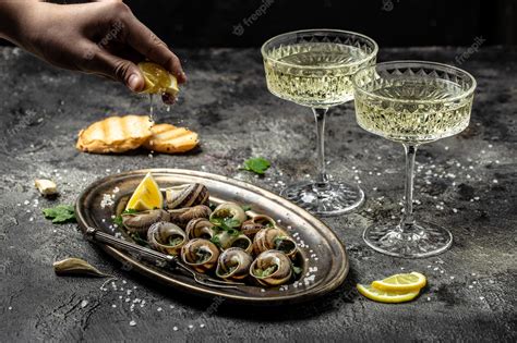 Premium Photo Baked Snails With Butter And Spice On Dark Background