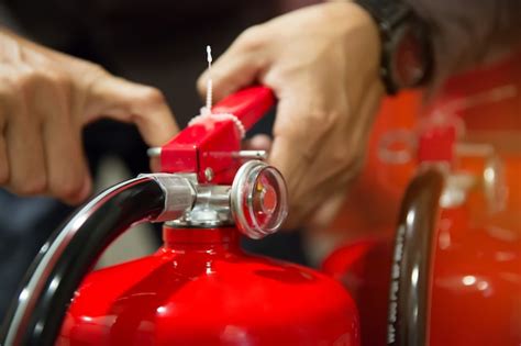 Premium Photo Engineers Are Pull The Safety Pin Of Fire Extinguishers