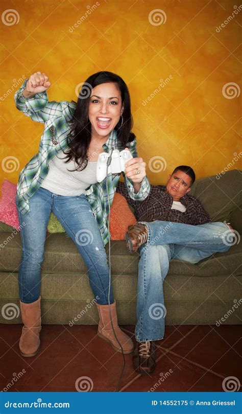 Hispanic Man Bored While Wife Plays Video Game Stock Image Image Of