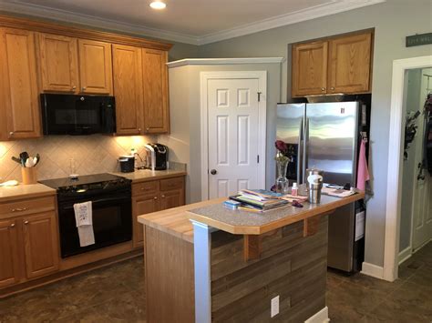 Accentuate a single cabinet piece. Caviar Oak Kitchen + Island cabinets - 2 Cabinet Girls