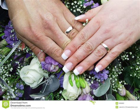 A wedding ring is exchanged at the wedding ceremony and represents the official bond of marriage. Wedding rings and hands 2 stock image. Image of purple ...