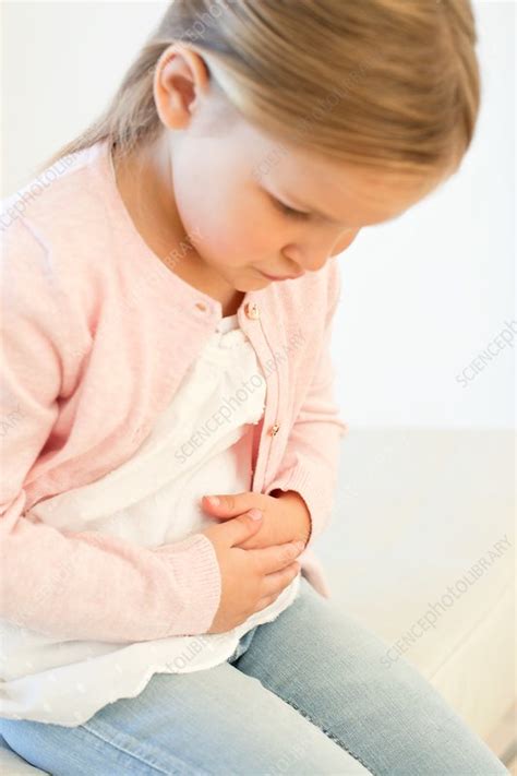 Young girl with stomach ache - Stock Image - F019/4053 - Science Photo 