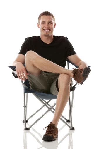 Young Man Sitting On A Chair Stock Photo Download Image