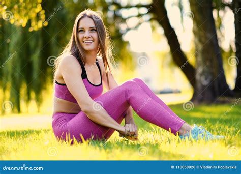 Portrait Of Smiling Sporty Female In A Pink Sportswear Stock Photo