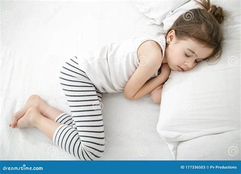 A Cute Little Girl Is Sleeping In A White Bed Stock Image Image Of