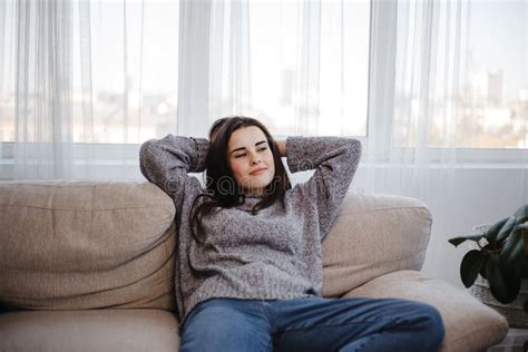 Young Woman Relaxing On A Couch In Living Room Stock Image Image Of