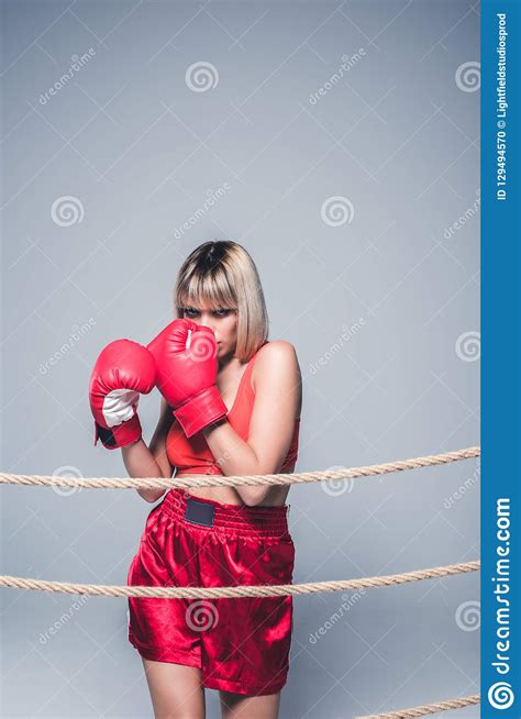 Portrait Of Beautiful Woman In Sportswear And Boxing Gloves Posing