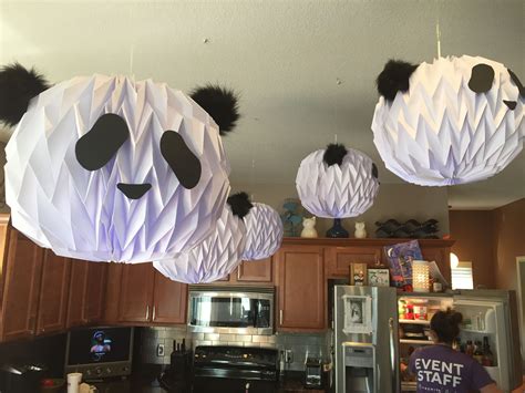 Three Panda Paper Lanterns Hanging From The Ceiling Above A Kitchen