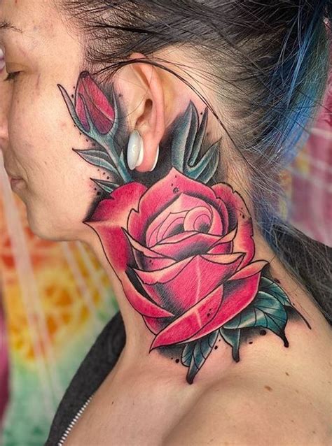 A Woman With A Rose Tattoo On Her Neck