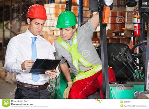 Supervisor Showing Clipboard To Forklift Driver Stock Image - Image of ...