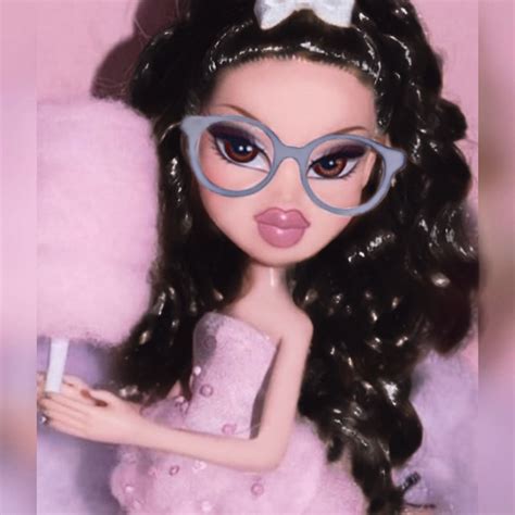 A Close Up Of A Doll Wearing Glasses And Holding A Cup In Her Hand